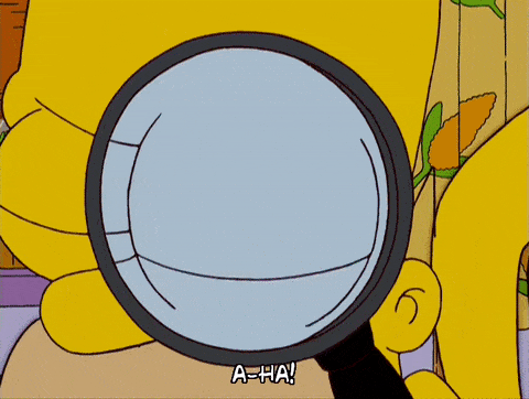 cartoon character homer using a magnifying glass